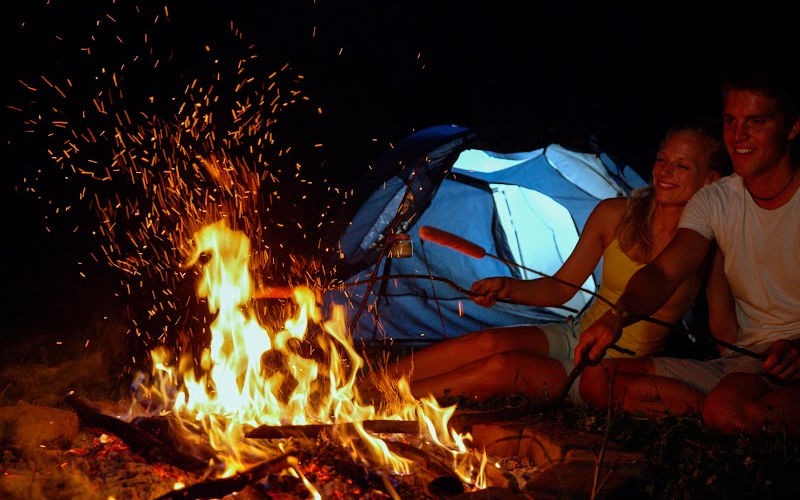 Couples by the campfire at night.