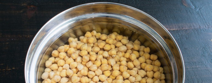 Dried chickpeas soaked in fresh bowl of water.