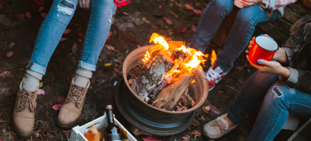 Wood burning in a firepit at night in the backyard.