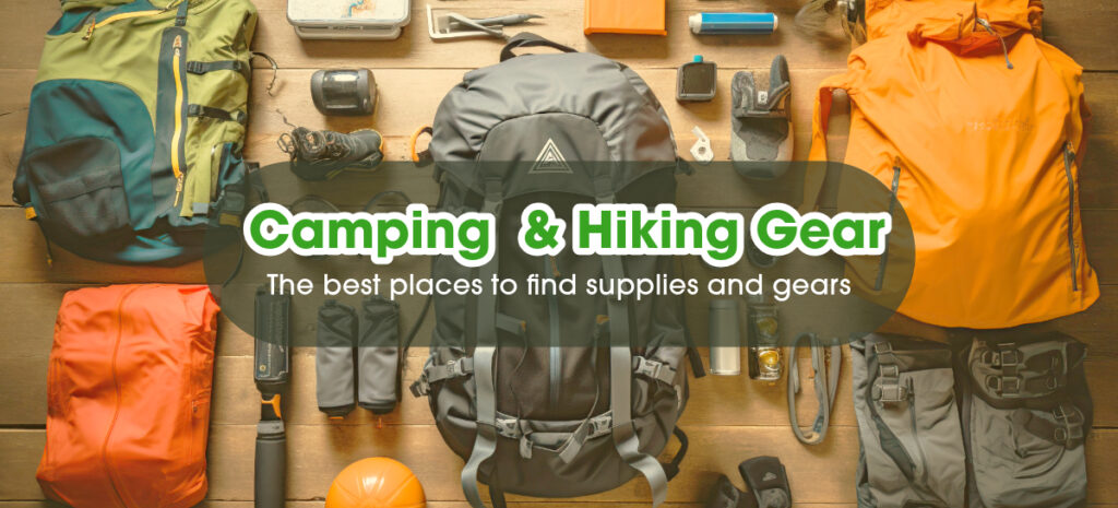 Hiking and camping gears lay on a wooden floor.