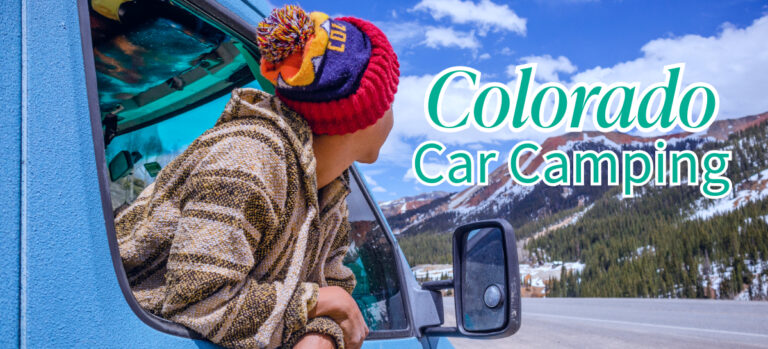 A person wearing rainbow colored winter hat popping out of car window and looking at snowed mountains.