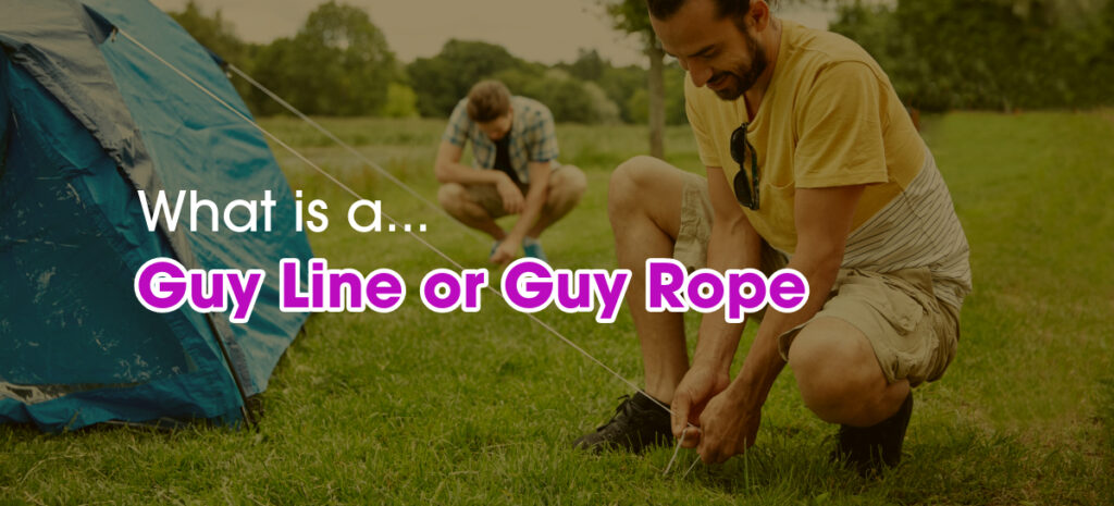 A man securing tent guy rope in a camping site.