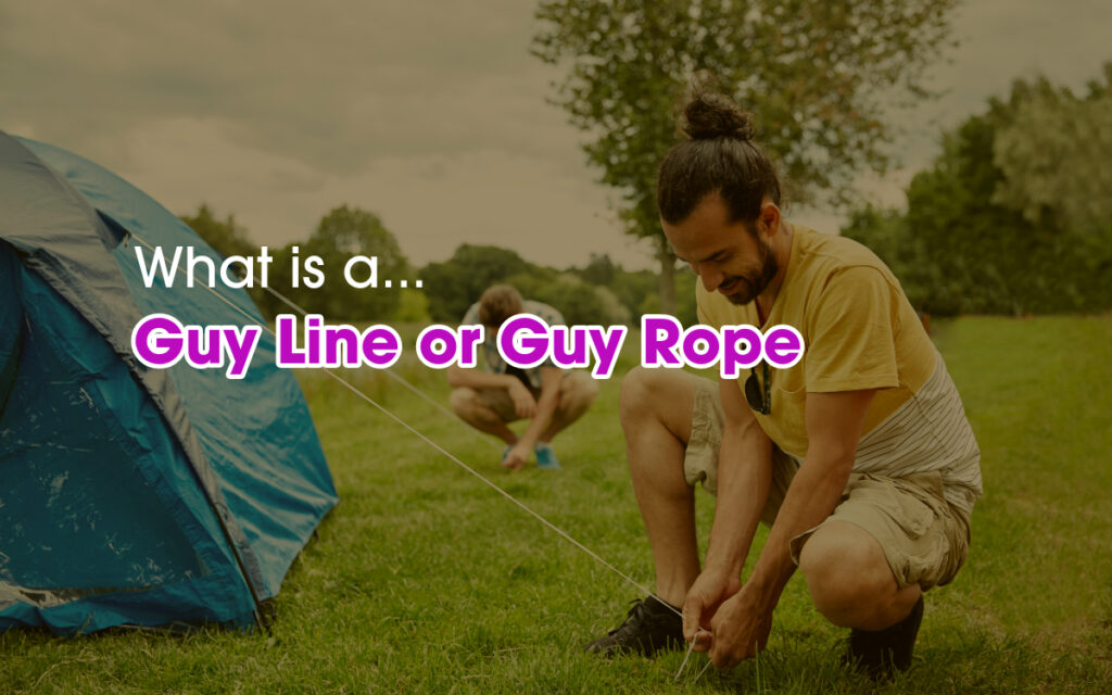 A man securing tent guy rope in a camping site.