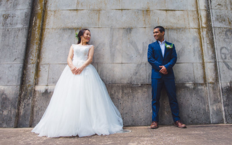 A bride and groom standing apart and looking at each other