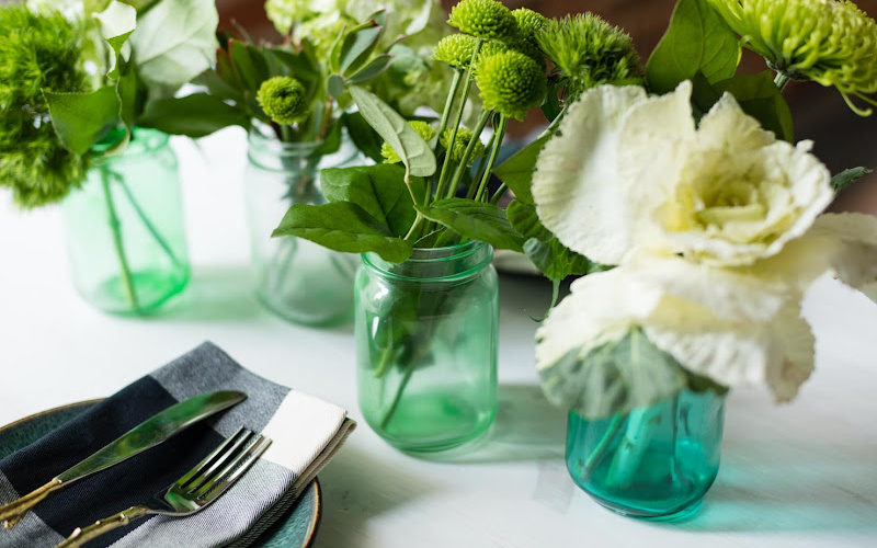 Tint mason jars displayed with flowers and dinnerware