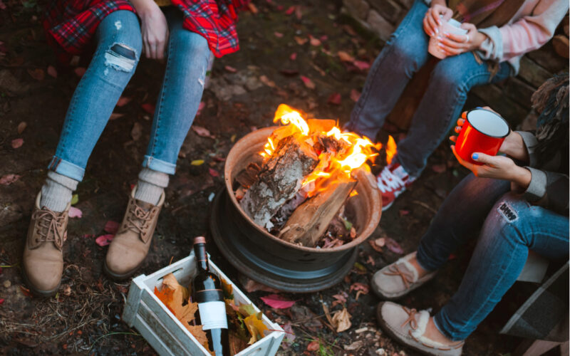 Wood burning in a firepit at night in the backyard.