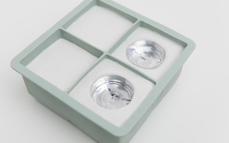 Two tealight candles in a square box