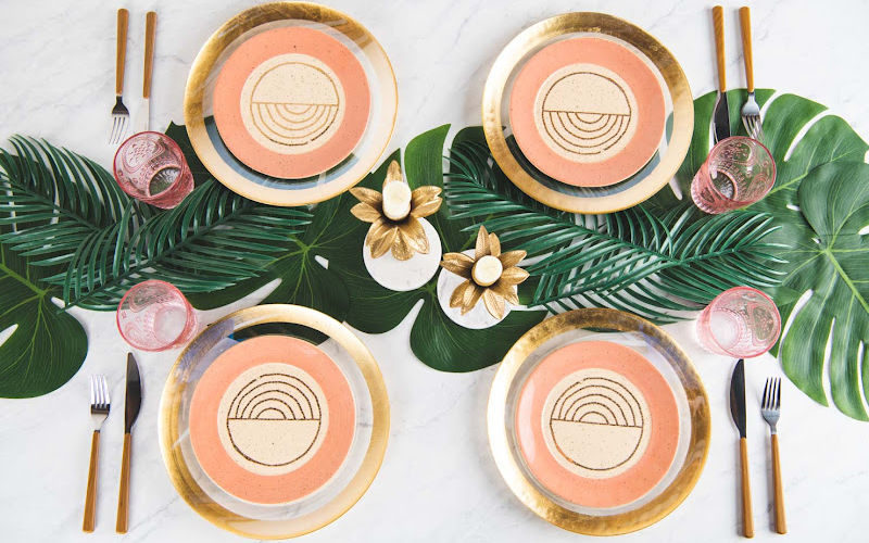 A set of dinnerware in peach and gold theme