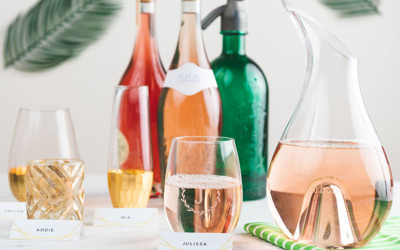 A dinner table with wine bottles and glasses