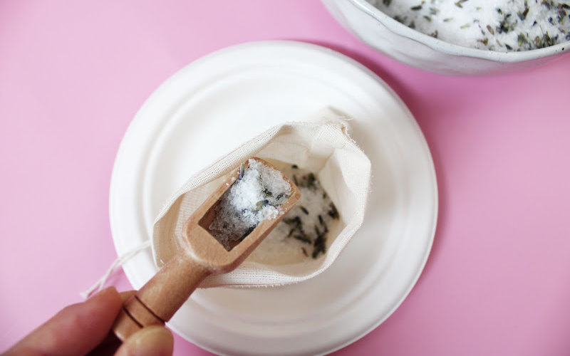 Scooping lavender foot soak with a bamboo salt scoop