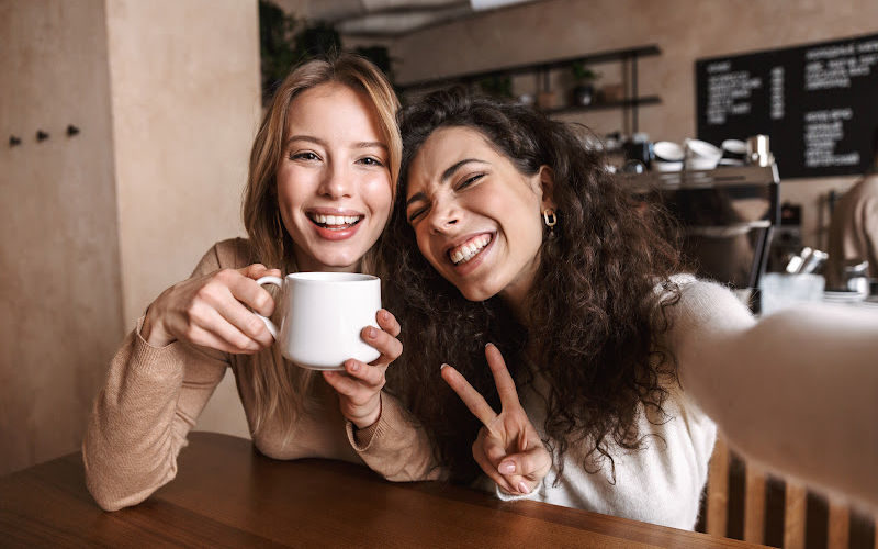 Two women taking a selfie at the coffee shop