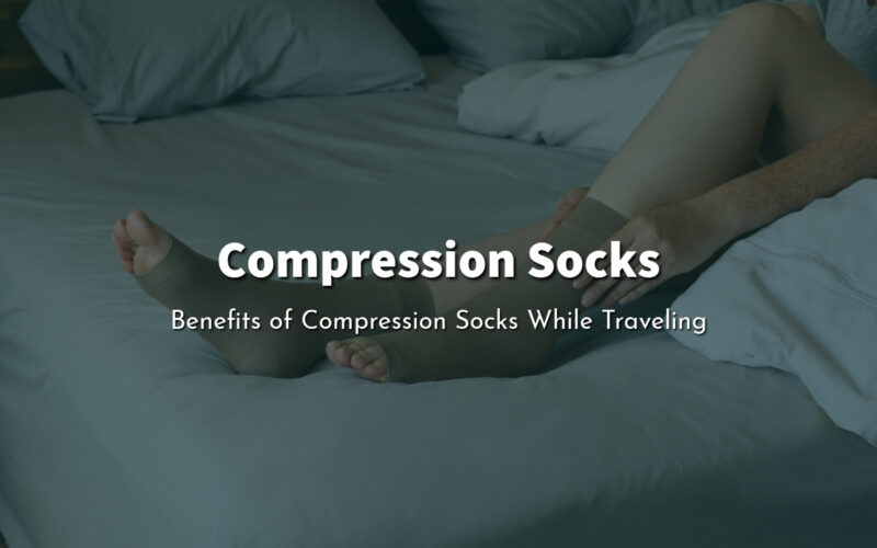 A person sitting on a bed and putting on a compression socks.